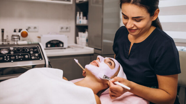 Beauty therapist completes treatment on client