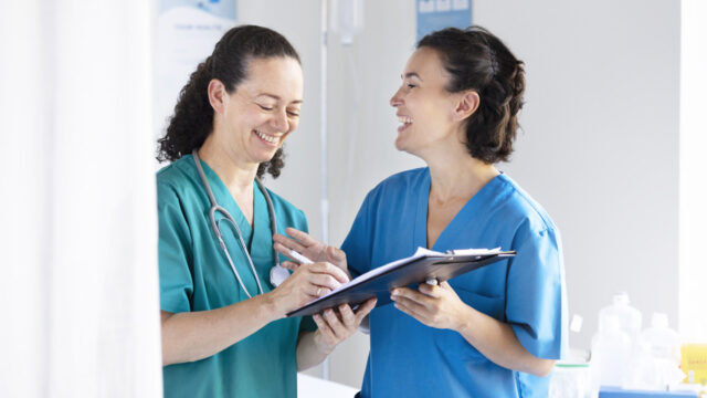 Nurses discuss patient notes 