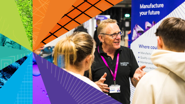 A Brooklands College staff member speaking with visitors at a careers or education event, with a Manufacture your future banner in the background