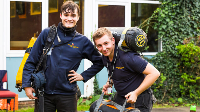 Public services students carry 15kg powerbags