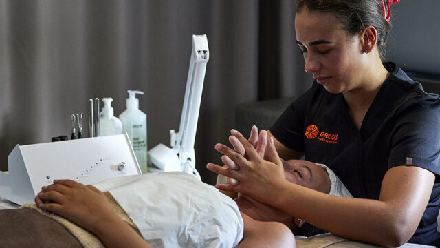 Beauty therapy student performs massage in Brooks Salon