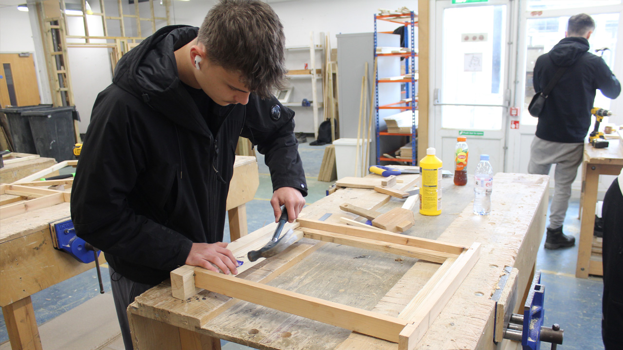 Carpentry student works in construction workshop