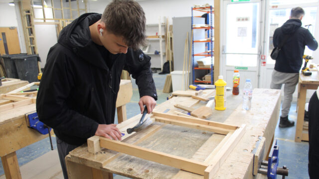 Carpentry student works in workshop