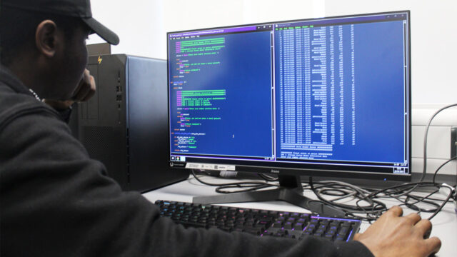 IT/ digital student shows off code in IT suite