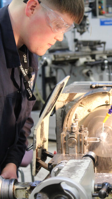 Student shows off manufacturing equipment