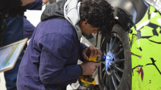 Vehicle maintenance student fixes car