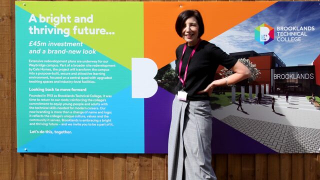 A woman stands beside a Brooklands Technical College banner announcing a £45m investment and redevelopment of its Weybridge campus