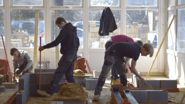 students completing their brickwork task